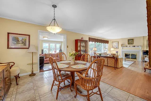 a dining room with furniture a chandelier and window