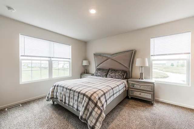 a bedroom with a bed and window