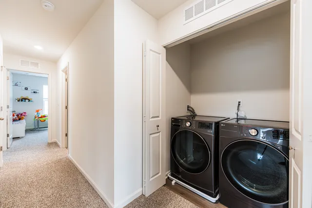 a view of storage and utility room with washer and dryer