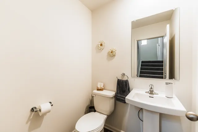 a bathroom with a sink mirror and toilet