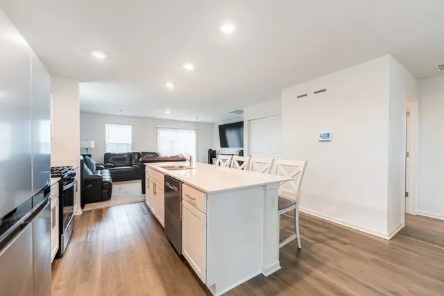 a large kitchen with a table and chairs