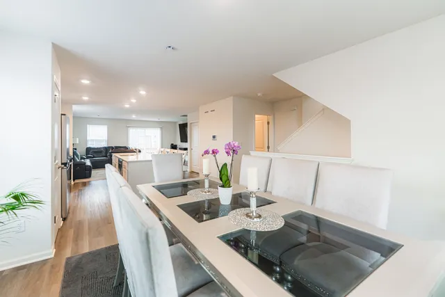 a view of a dining room with furniture and a potted plant
