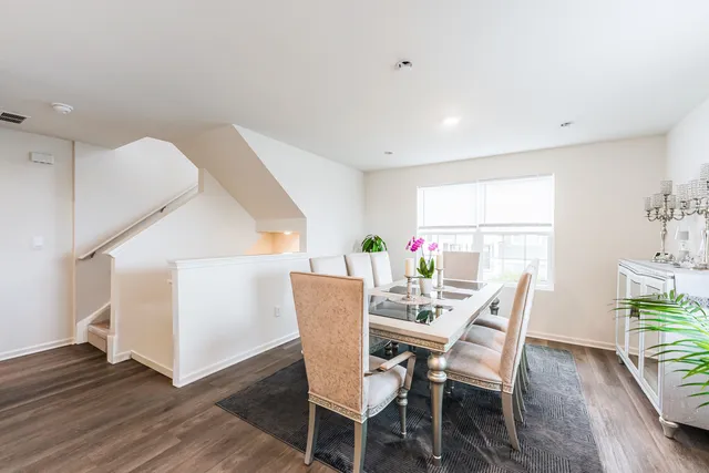 a view of a dining room with furniture and wooden floor