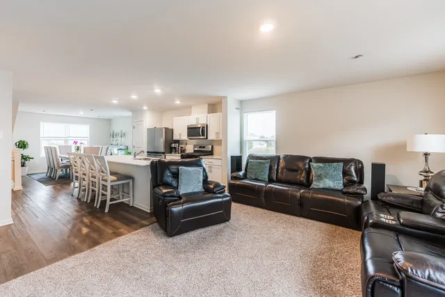 a living room with furniture and kitchen view