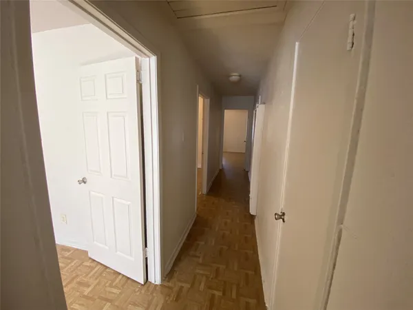 a view of a hallway with the wooden floor