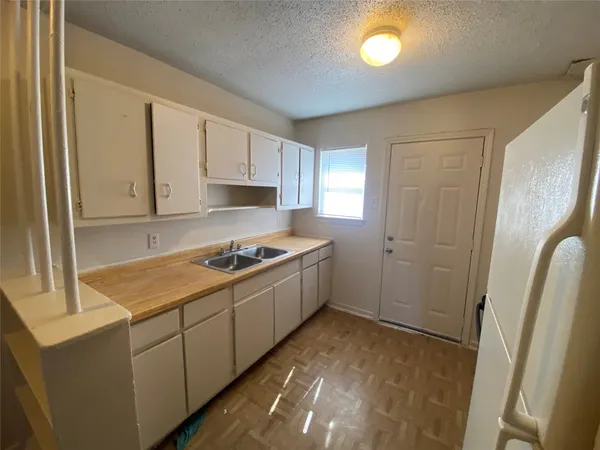 a kitchen with a stove a sink and a refrigerator