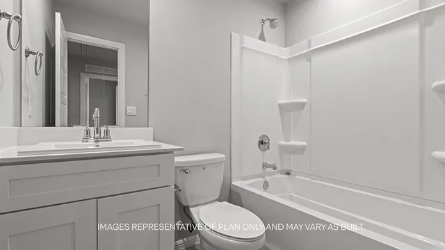 a bathroom with a sink a toilet a mirror and shower