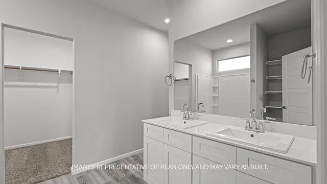 a bathroom with a double vanity sink and a mirror