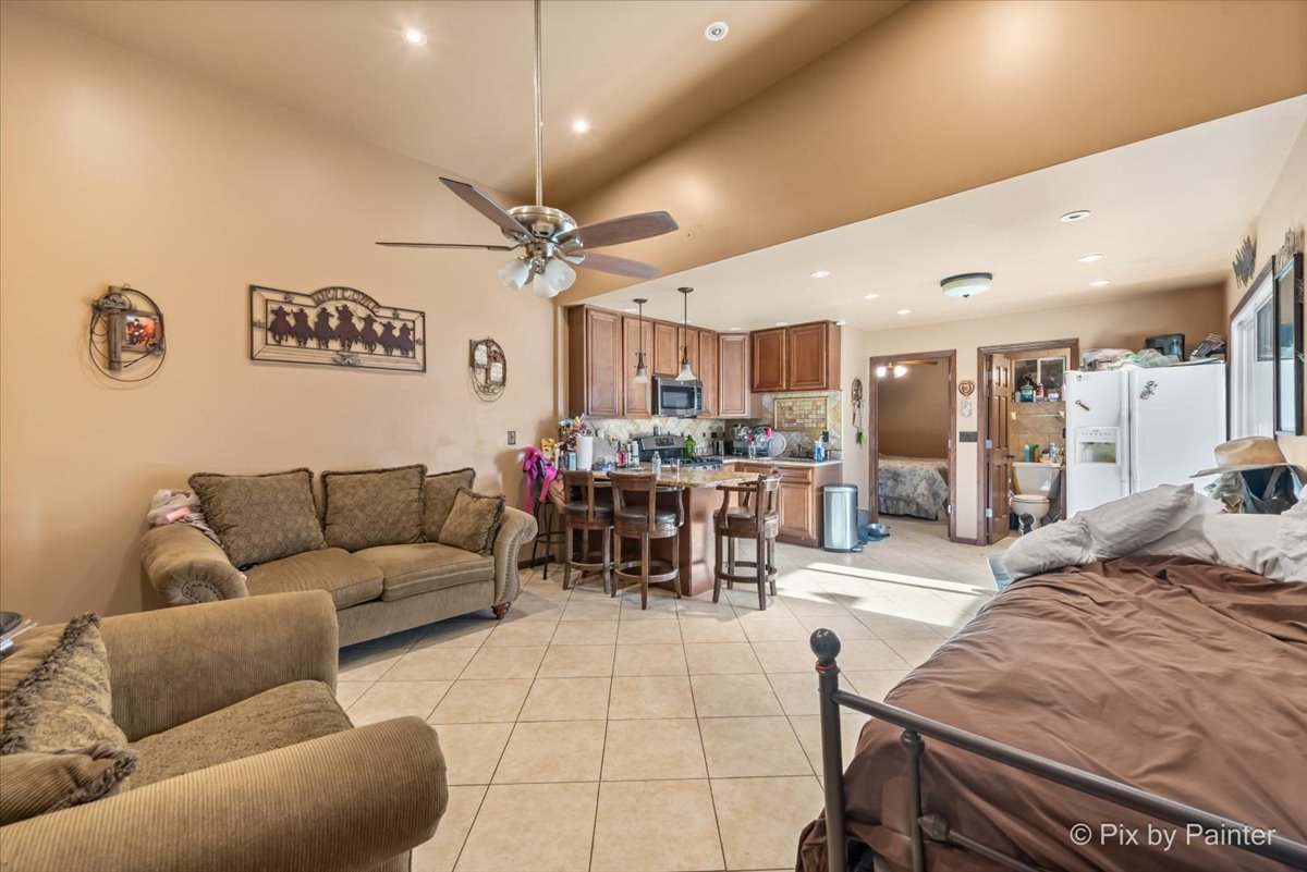 5-n487 County Line Road Maple Park, IL 60151 - Photo 3 of 44 a living room with furniture and a dining table with kitchen view