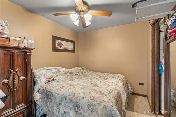 a bedroom with a bed and a chandelier