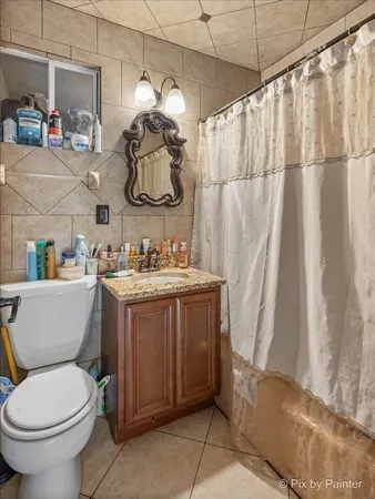 a bathroom with a sink a toilet and shower curtain