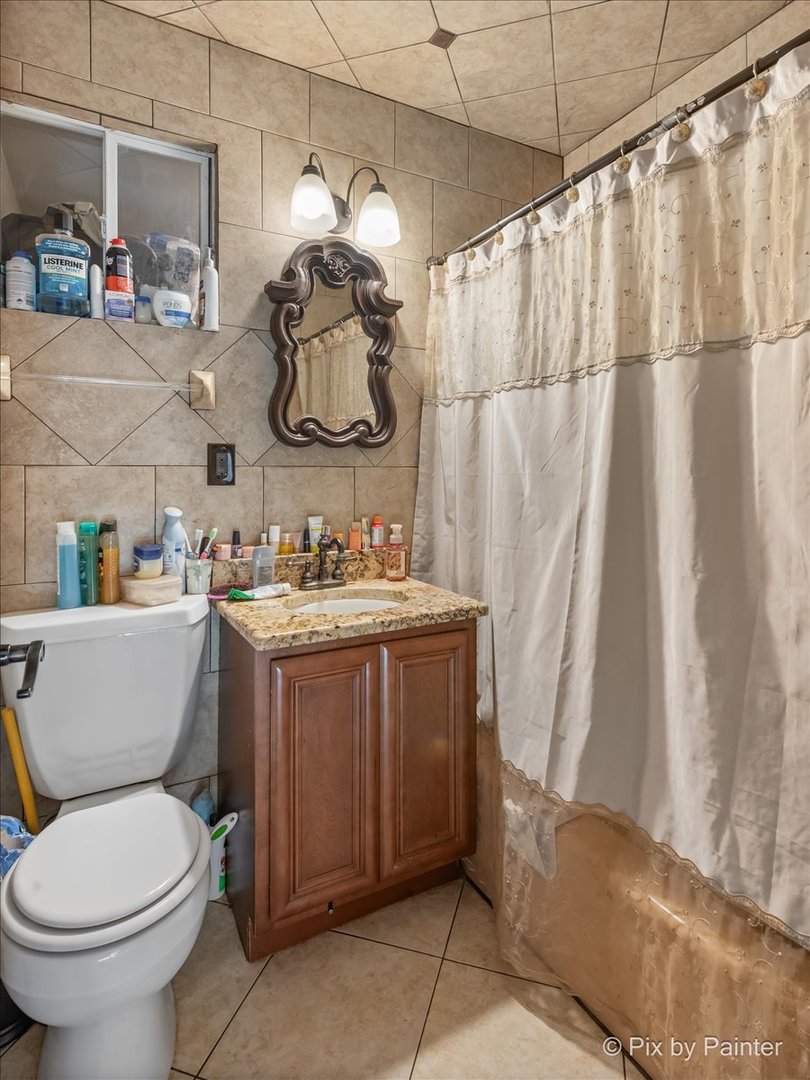 5-n487 County Line Road Maple Park, IL 60151 - Photo 6 of 44 a bathroom with a sink a toilet and shower curtain