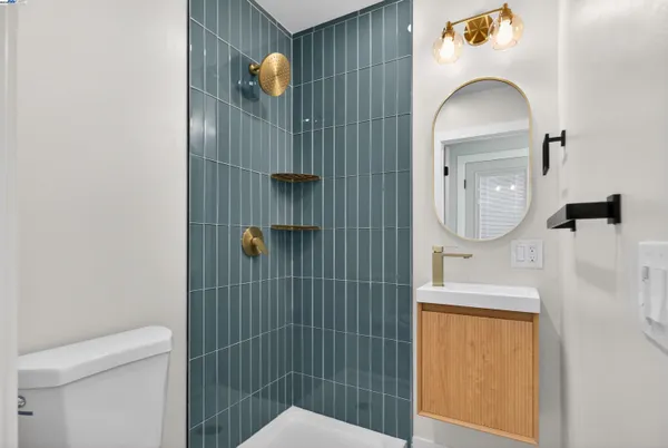 a bathroom with a sink a toilet and mirror