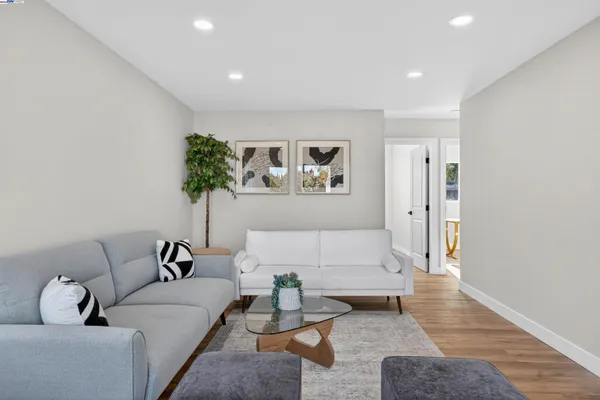 a living room with furniture and wooden floor