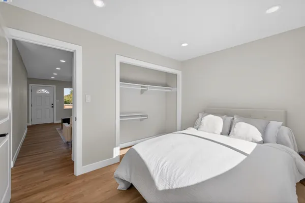 a bedroom with a bed and wooden floor