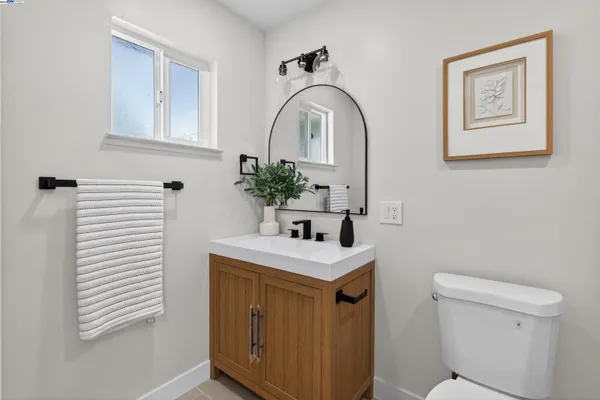 a bathroom with a sink a toilet and a mirror