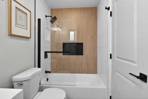 a bathroom with a toilet and a bathtub
