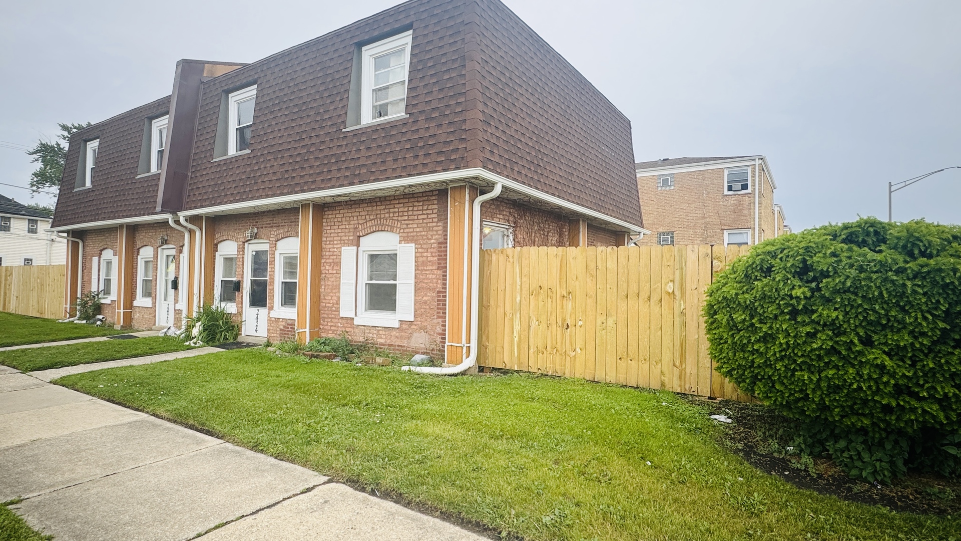 2420 Randolph Street Bellwood, IL 60104 - Photo 2 of 13 a view of a brick house with a yard