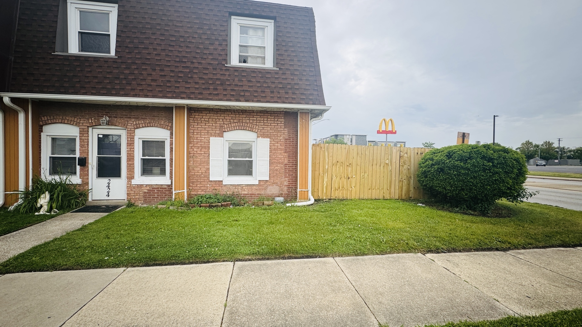 2420 Randolph Street Bellwood, IL 60104 - Photo 3 of 13 a front view of a house with a yard and garage
