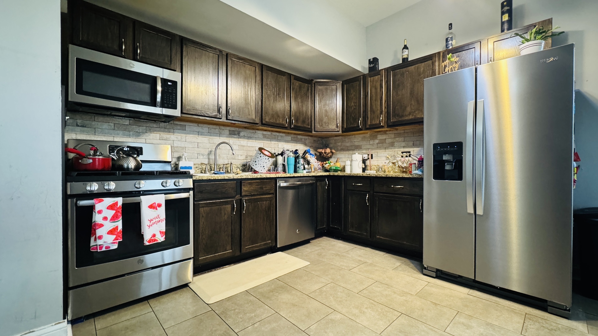 2420 Randolph Street Bellwood, IL 60104 - Photo 6 of 13 a kitchen with stainless steel appliances granite countertop a refrigerator and a stove top oven