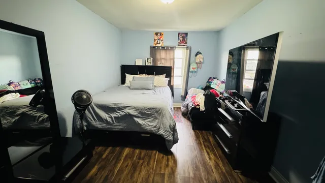 a bedroom with a bed and a mirror