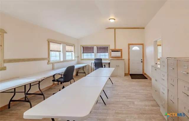 a living room with furniture a dining table and chairs