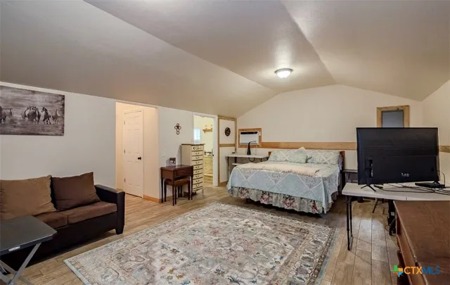 a bedroom with furniture and a flat screen tv