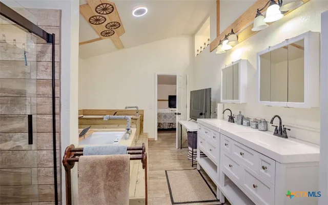 a large bathroom with a double vanity sink a mirror and a shower
