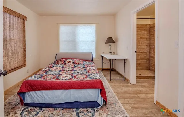 a bedroom with a bed and a table in it