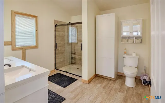 a bathroom with a toilet and a shower