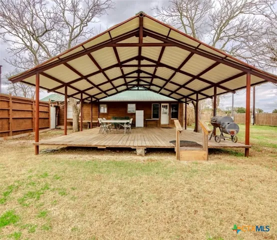 a backyard of a house with porch and patio