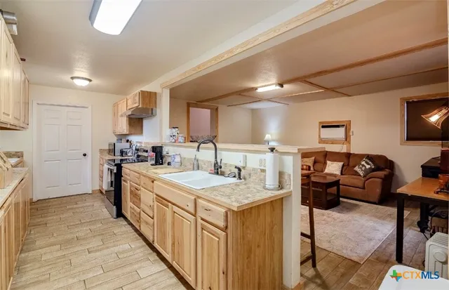 a kitchen with counter space sink stove and refrigerator