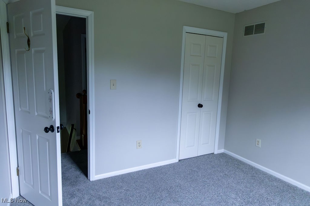3333 Dayton Road Madison, OH 44057 - Photo 27 of 48 Unfurnished bedroom with carpet flooring, a closet, and baseboards