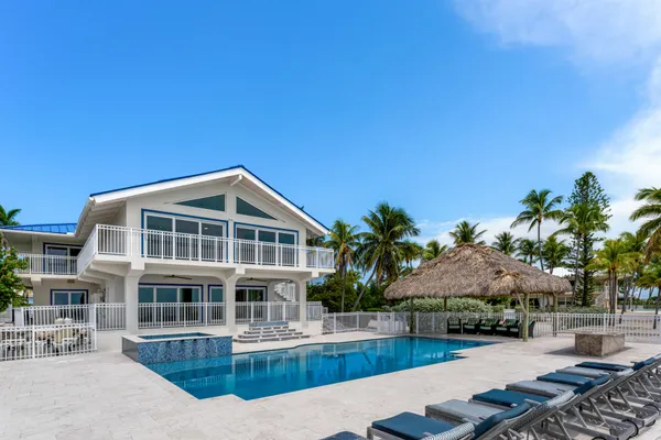 a view of a house with swimming pool and sitting area