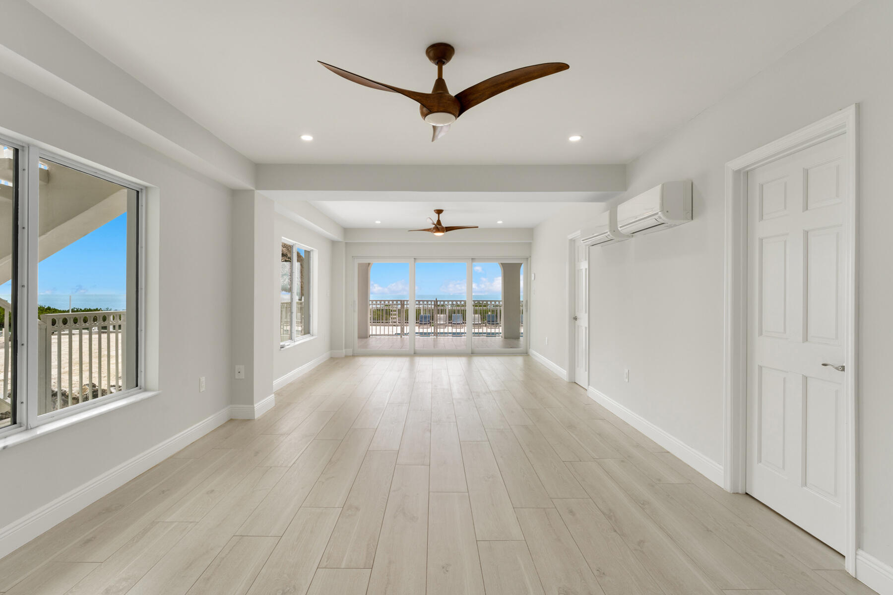 308 Sabal Street Duck Key, FL 33050 - Photo 20 of 87 a view of a hallway with wooden floor and a ceiling fan