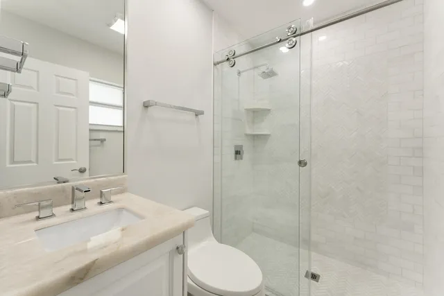 a large white building with a yard and lawn chairs