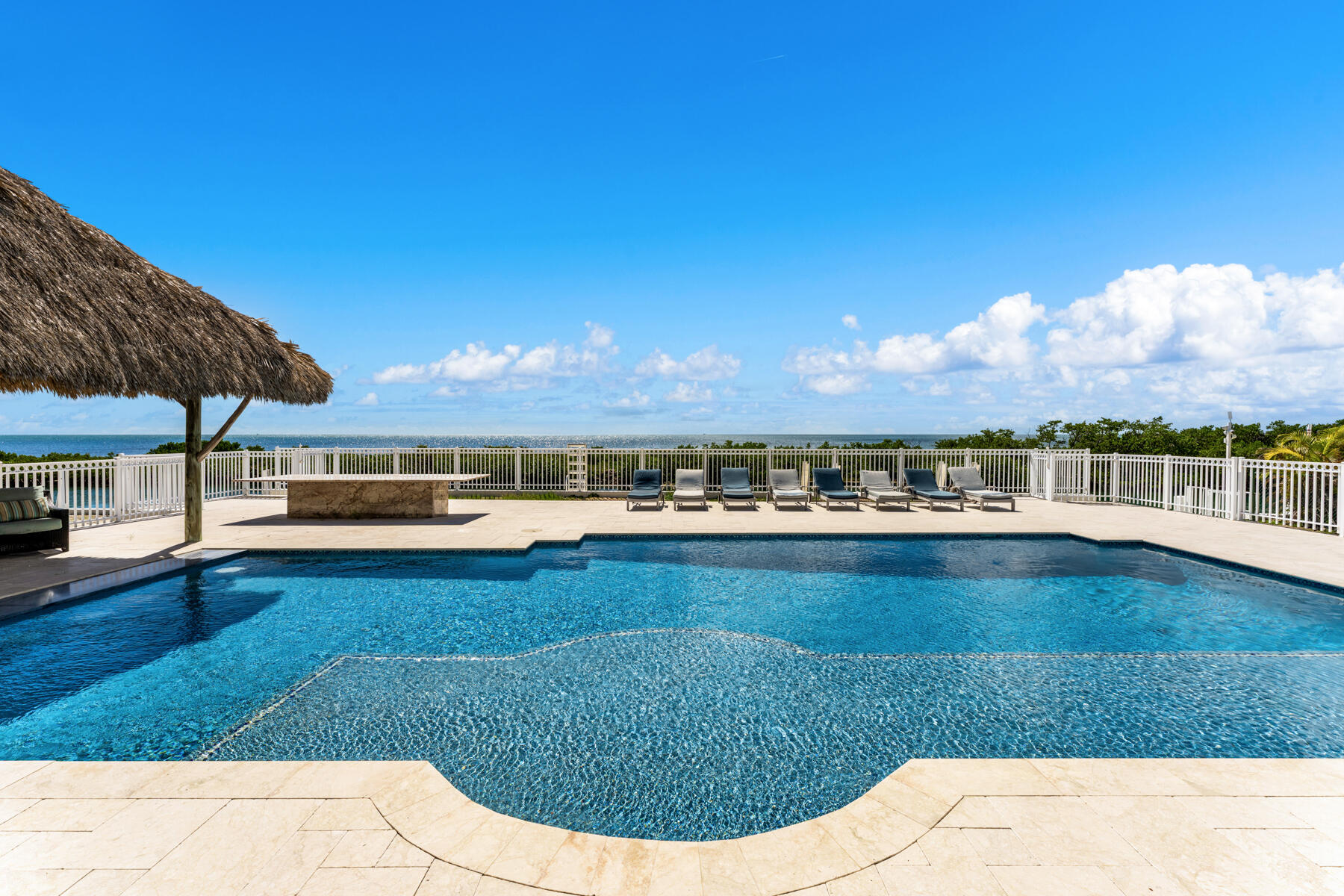 308 Sabal Street Duck Key, FL 33050 - Photo 6 of 87 a view of a swimming pool and lounge chair