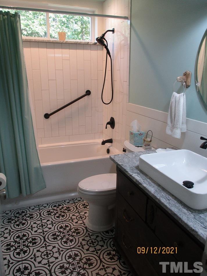91 Boykin Road Clinton, NC 28328 - Photo 11 of 17 a bathroom with a granite countertop sink toilet and shower