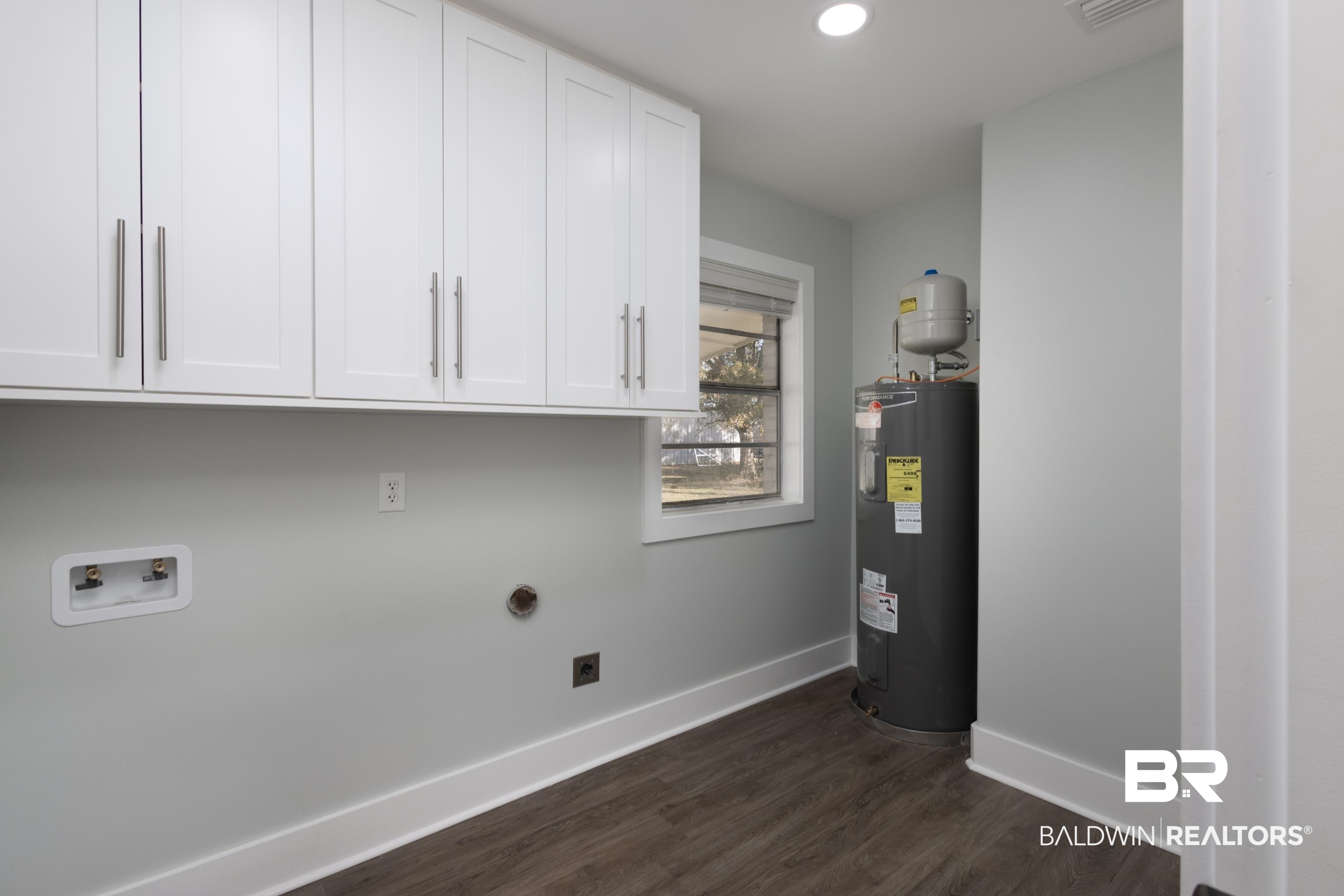 18267 Highway 98 Foley, AL 36535 - Photo 21 of 26 Laundry area featuring water heater, cabinet space, hookup for a washing machine, dark wood finished floors, and hookup for an electric dryer