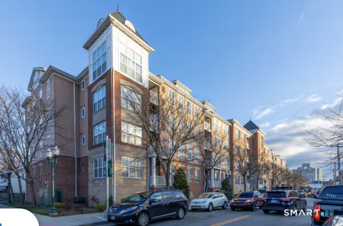 25 Adams Avenue, Unit 112 Stamford, CT 06902 - Photo 1 of 17 a city street lined with buildings and cars