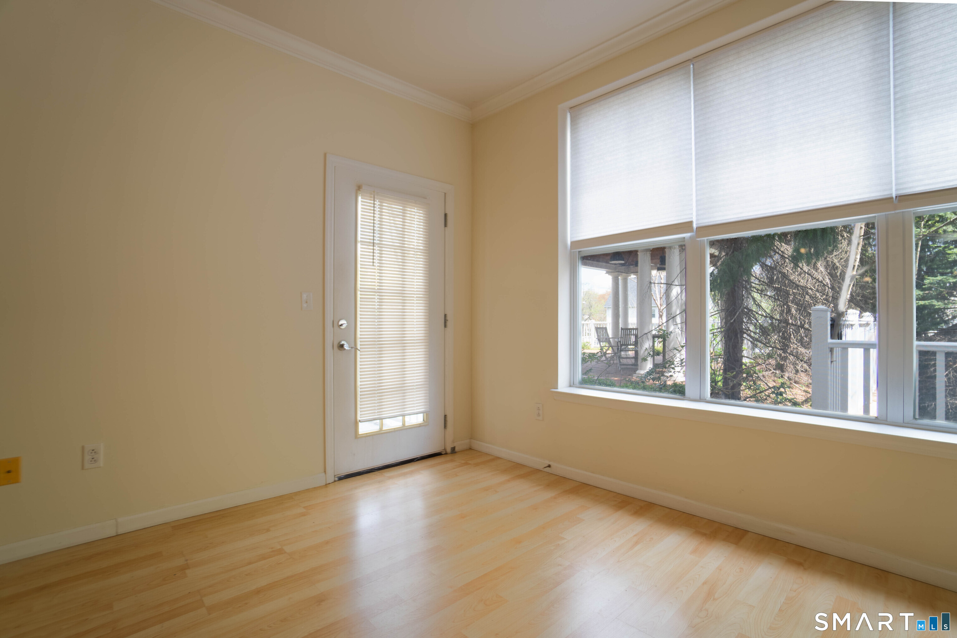 25 Adams Avenue, Unit 112 Stamford, CT 06902 - Photo 12 of 17 an empty room with wooden floor and windows