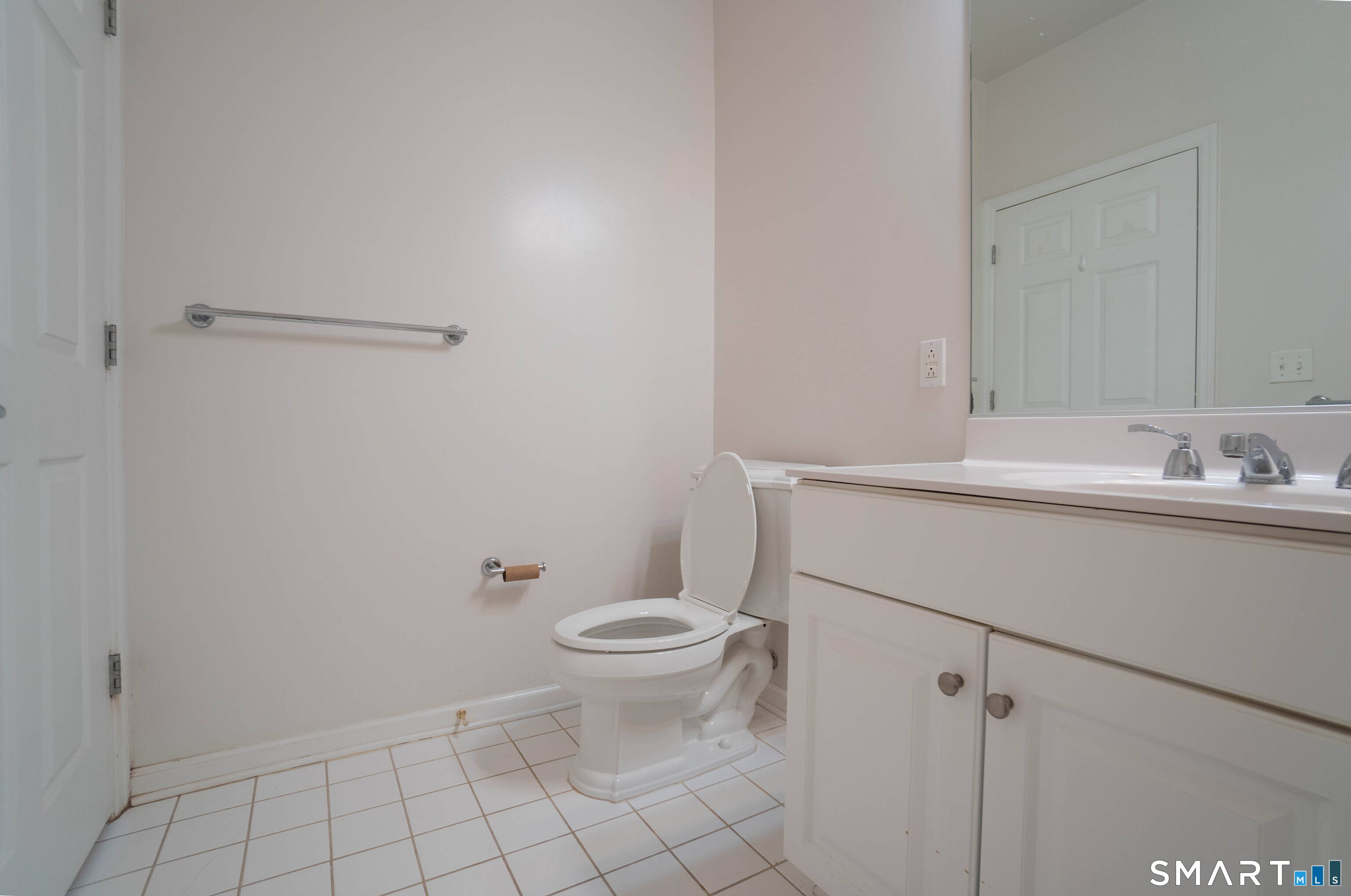 25 Adams Avenue, Unit 112 Stamford, CT 06902 - Photo 14 of 17 a bathroom with a sink toilet and vanity