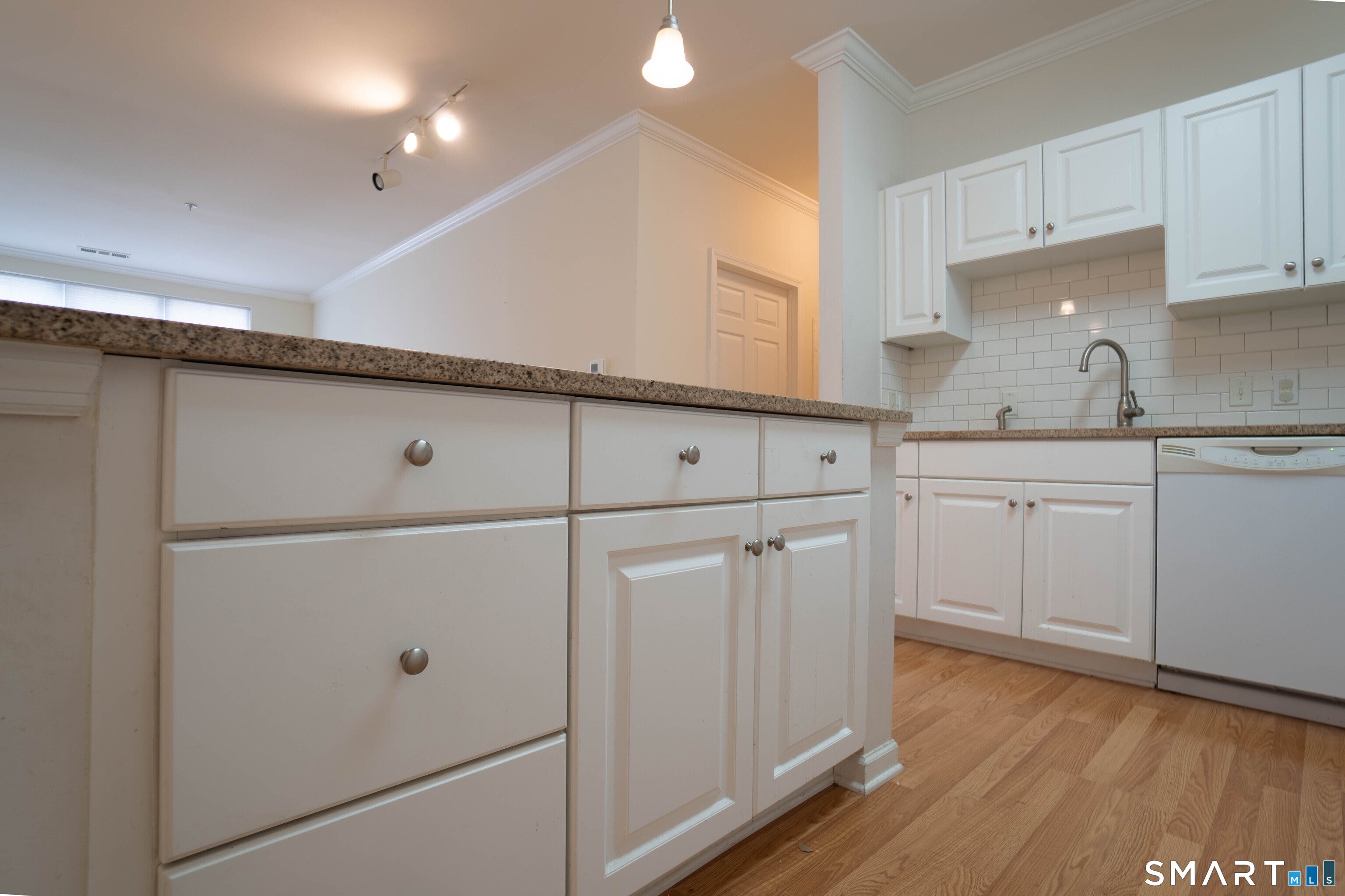 25 Adams Avenue, Unit 112 Stamford, CT 06902 - Photo 8 of 17 a kitchen with white cabinets and white appliances