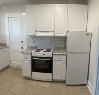1360 Rhodes Street, Unit D Columbus, GA 31901 - Photo 9 of 11 a kitchen with white cabinets and white appliances
