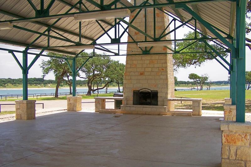 78 Dodder Lane Spring Branch, TX 78070 - Photo 19 of 24 View of patio featuring an outdoor brick fireplace and a water view
