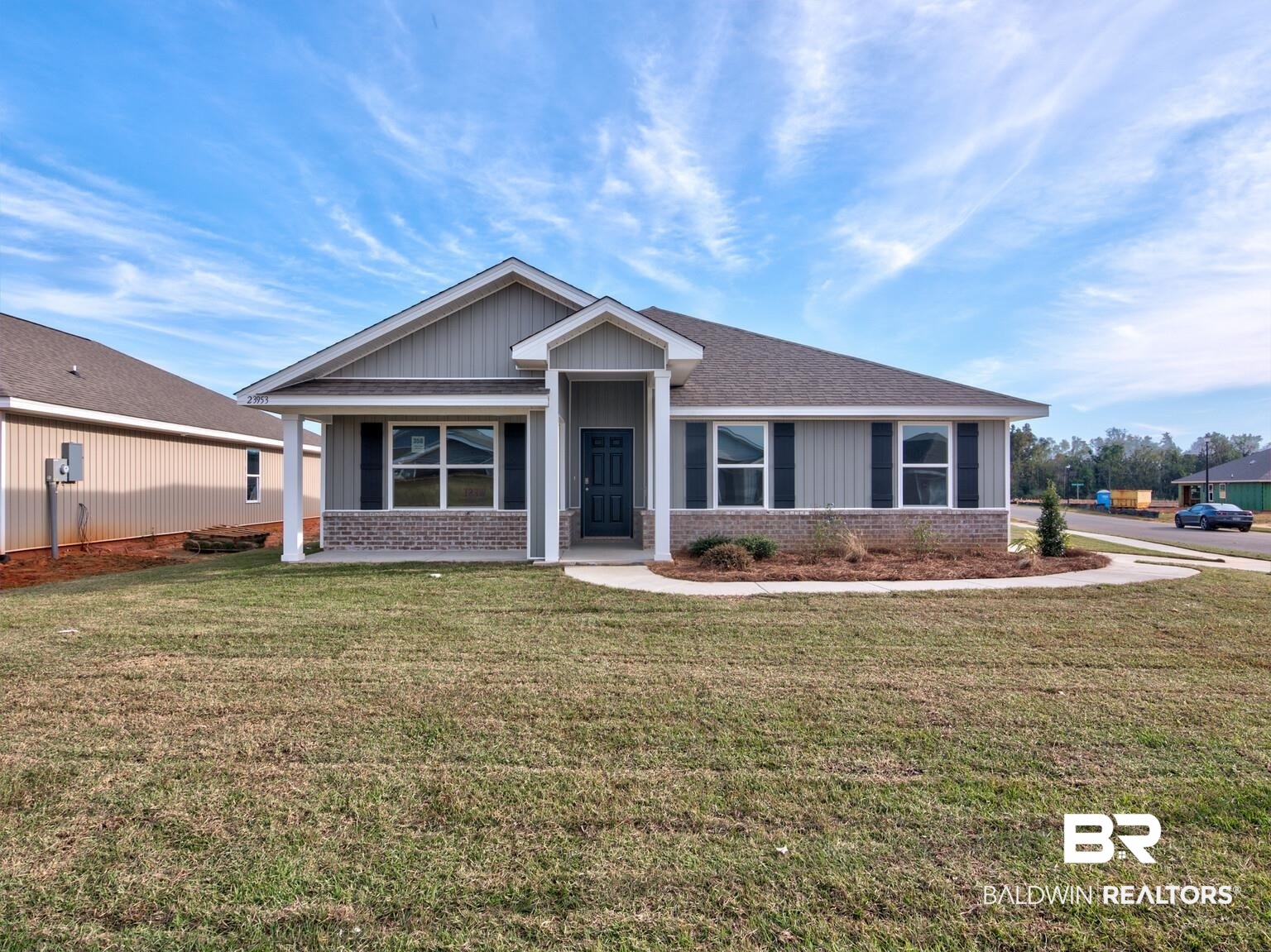 23953 Citation Loop Daphne, AL 36526 - Photo 1 of 49 View of front facade featuring brick siding, a front lawn, board and batten siding, and roof with shingles