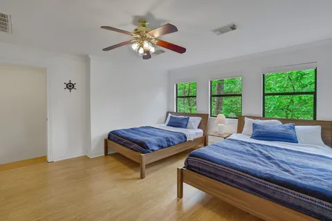 a bedroom with a bed and windows