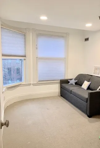a living room with furniture and a bathtub