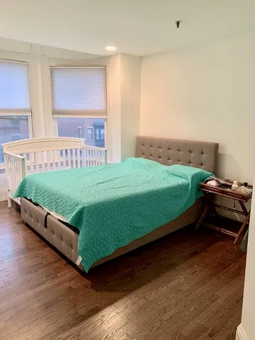 a bed sitting in a bedroom next to a window