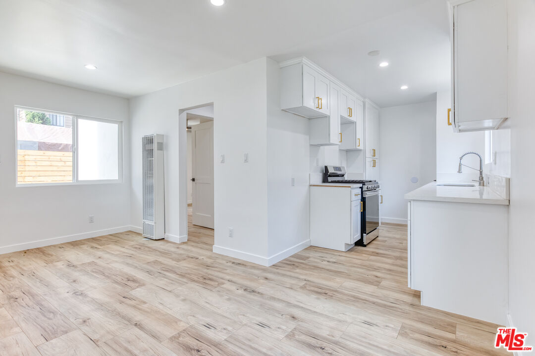 a kitchen with a refrigerator and a sink